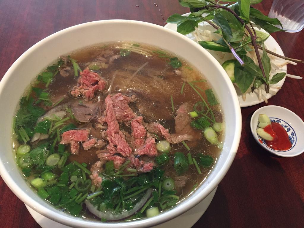 Pho Tai Bap · Rare steak slices and shank with rice noodle soup.