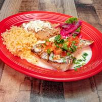 Red Snapper · Grilled red snapper with a white queso cheese sauce, topped with pico de gallo and cilantro....