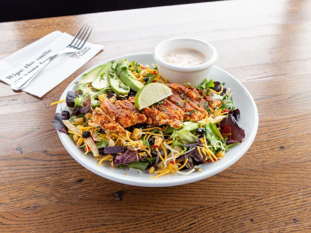 Southwest Chicken Salad · Mixed greens, grilled chicken, corn, black beans, cheddar cheese, avocado and tortilla crisps topped with our housemade creamy chipotle ranch dressing.