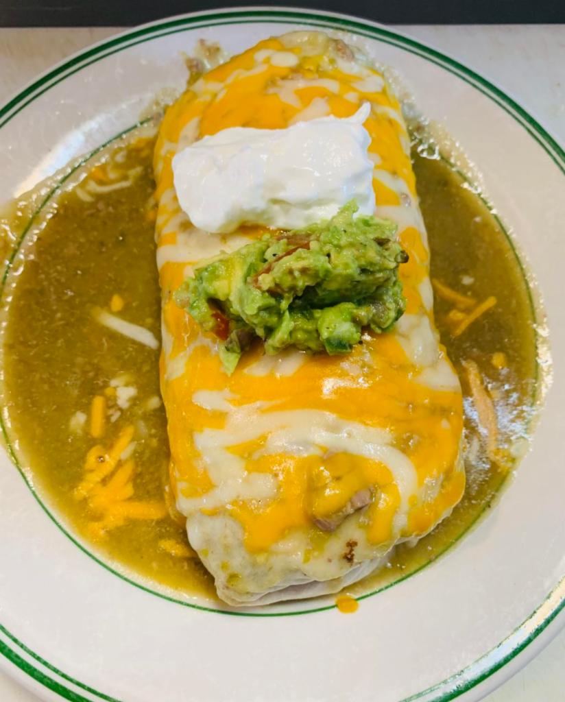 Nopales Burrito · Cactus, onion, jalapenos, tomato and eggs, topped with chile verde sauce topped with Jack cheese, sour cream and guacamole.