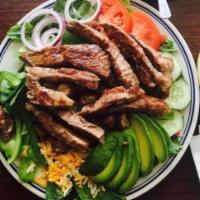 New York Steak Salad · Grilled steak, chopped over a green salad, cucumber and your choice of dressing.