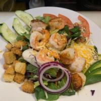 Shrimp Salad · Chopped shrimp over a green salad with tomato, cucumber, avocado, mixed cheese and croutons.