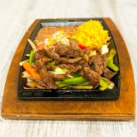 Juicy Steak Fajita · Grilled steak served on a sizzling platter over a bed of colorful sauteed bell peppers and o...