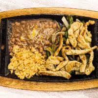 Smoky Chicken Fajitas · Grilled tender chicken breast served on a sizzling platter over a bed of colorful sauteed be...