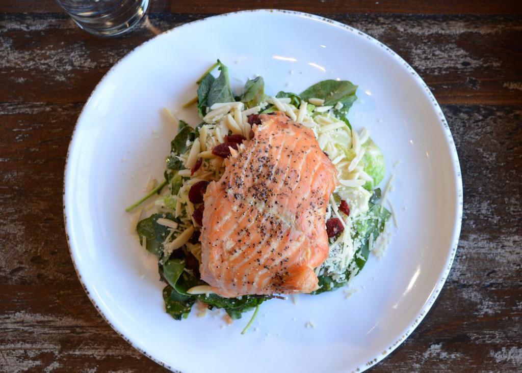Salmon & Brussels Salad · Smoked salmon filet served over a bed of kale and brussels sprouts with dried cranberries, bacon, fresh grated parmesan, and toasted almonds served with maple tahini dressing.