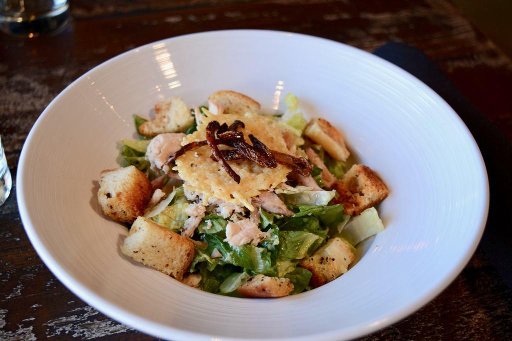 Caesar Salad · Romaine hearts, garlic croutons, Parmesan crisps and crispy shallots served with Caesar dressing.