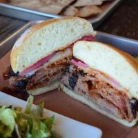 Sliced Brisket Sandwich · Sliced brisket with signature sauce topped with melted provolone cheese, pickled onions serv...