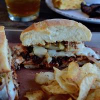 Pulled Chicken Sandwich · Pulled smoked chicken, crispy onions, pickled green tomatoes, bacon, signature sauce and mel...