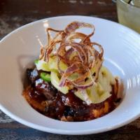 WRB Grits & Brisket · Baked cheese grits topped with chopped brisket, pickled green tomatoes, jalapenos, crispy on...