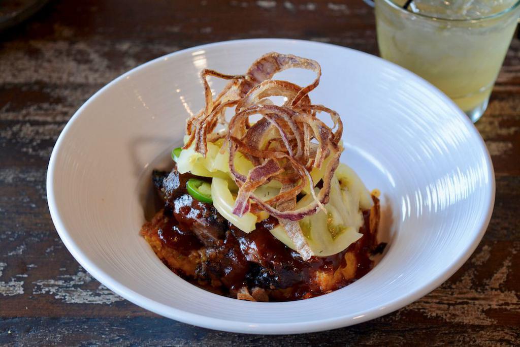 WRB Grits & Brisket · Baked cheese grits topped with chopped brisket, pickled green tomatoes, jalapenos, crispy onions and signature sauce.