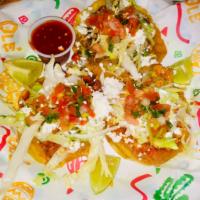 Sopes Mixtos · 3 Homemade corn tortillas with Carnitas, Chicken and Al Pastor. Re fried pinto beans, lettuc...