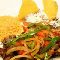 Carne Asada Encebollada · Seasoned grilled steak, with sauteed onions, pepper, rice, beans, salad and corn tortillas.