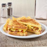The Grand Slamwich® · Scrambled eggs, sausage, bacon, ham, and American cheese on potato bread grilled with a mapl...