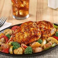 Bourbon Chicken Skillet · Grilled seasoned chicken breasts covered with a bourbon glaze atop seasoned red-skinned pota...