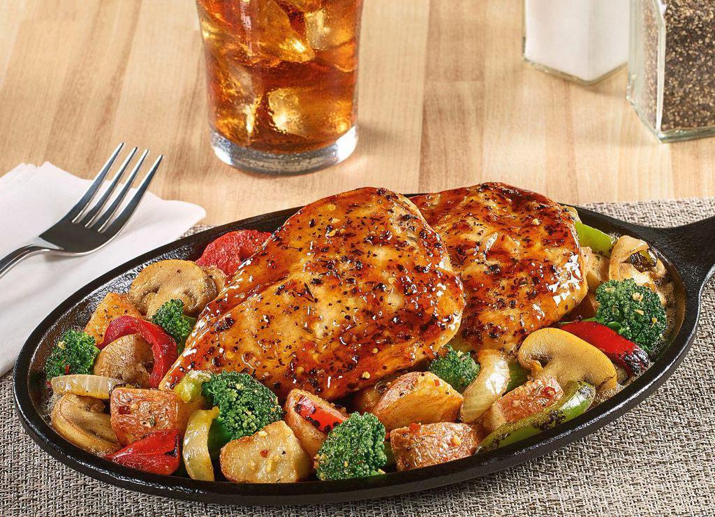 Bourbon Chicken Skillet · Grilled seasoned chicken breasts covered with a bourbon glaze atop seasoned red-skinned potatoes, broccoli, fire-roasted bell peppers & onions and mushrooms.