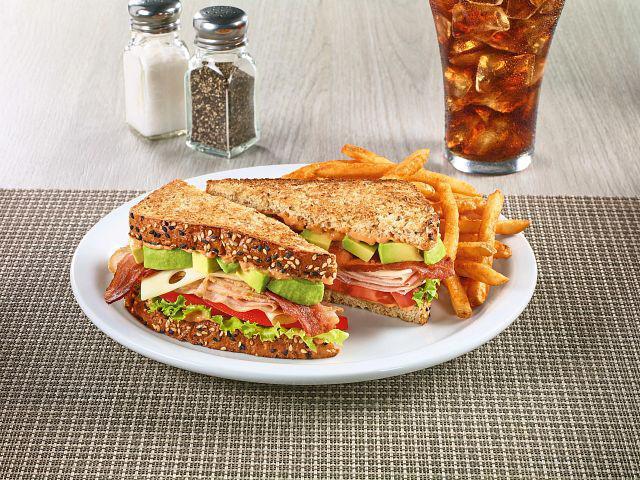 Cali Club Sandwich · Turkey breast, ham, crisp bacon, Swiss cheese, and fresh avocado on toasted 7-grain bread with sun-dried tomato mayo, lettuce and tomato.