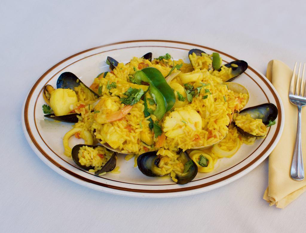 Paella Las Placitas · Our famous Spanish rice dish with shrimp, scallops, calms, mussels, squid and chicken.