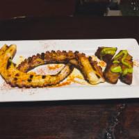 Pulpo a la Parrilla · Grilled Galician octopus with a side of fried potatoes, topped with parsley aioli.