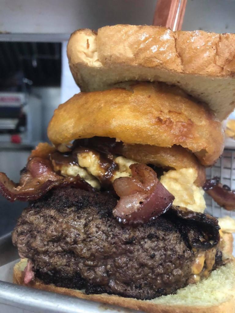 1 lb. The Kitchen Burger · Angus burger stuffed with cheddar cheese, fried pickles, hickory smoked bacon, onion rings, steak sauce, and Texas toast.