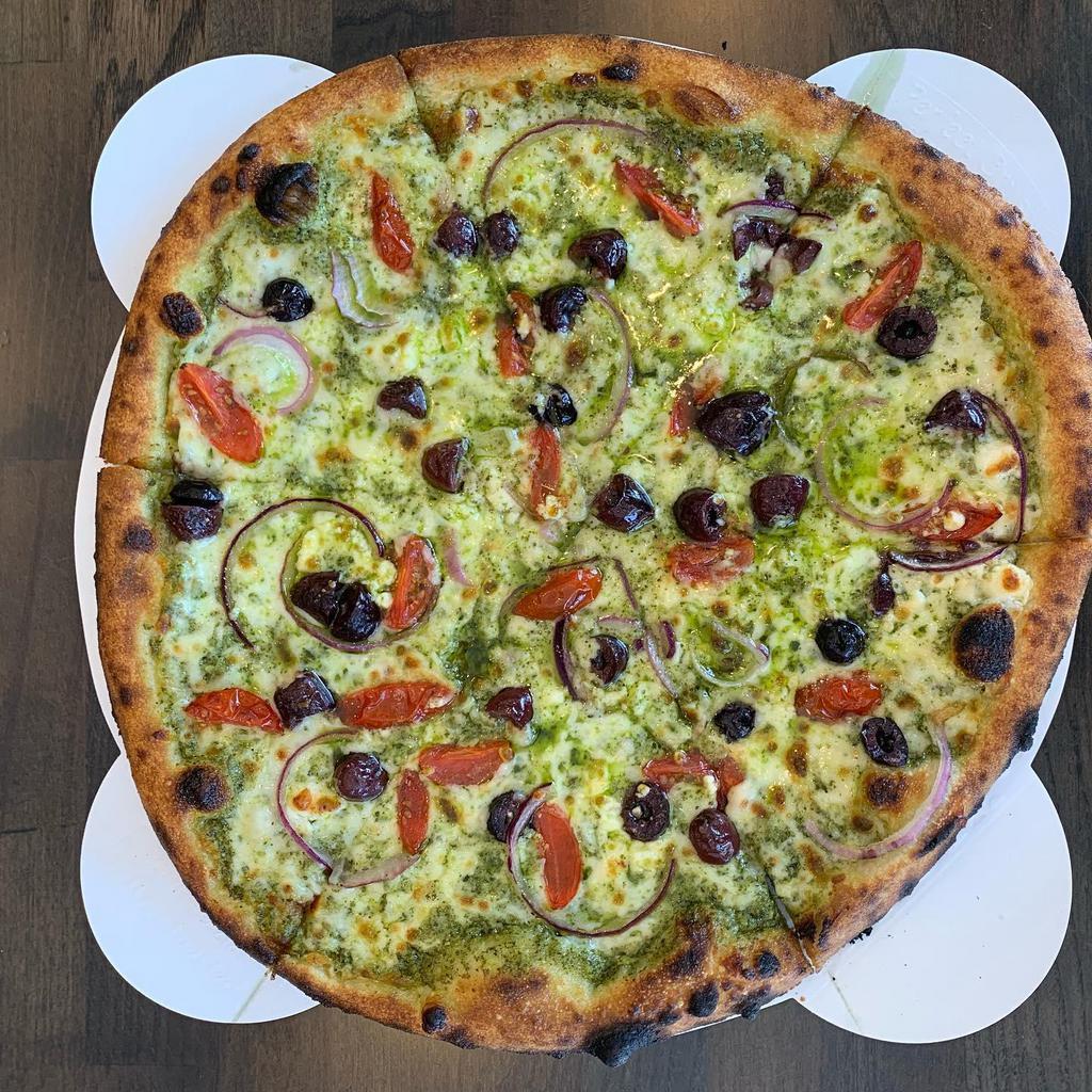 Greek Pizza · Hand-stretched Neapolitan crust (imported flour from Italy), pesto, feta cheese, four blend mozzarella cheese, banana pepper, greek Kalamata olives, red onion and tomato.