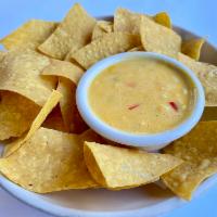 Chips & Queso · Spicy Texas style queso cheese dip. Served with house tortilla chips.
