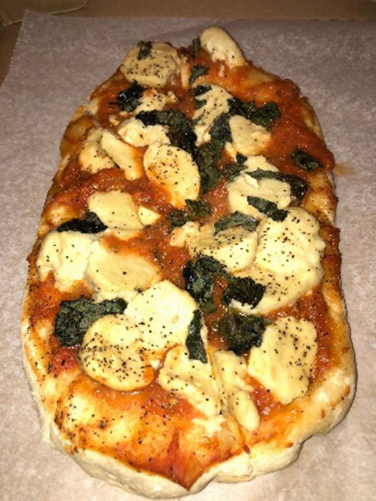 Margherita Pizza · Sourdough bread, slow-cooked marinara, homemade vegan mozzarella, and fresh basil.