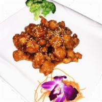 Sesame Chicken · Served crispy in tangy orange sauce. Served with white rice or brown rice.