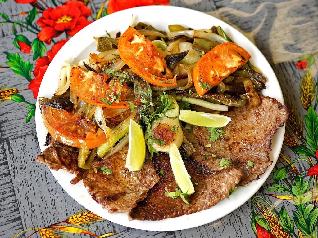Bistec con Nopales · Sirloin steak with cactus. Grilled sirloin steak with onions and paprika seasoning, topped with a whole leaf of sliced, grilled Mexican cactus plant. Served with rice, beans and corn tortilla.