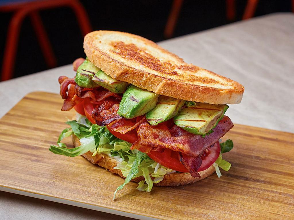 BLT & A Sandwich · Applewood smoked bacon, lettuce blend, tomatoes, avocado, garlic aioli and griddled sourdough.