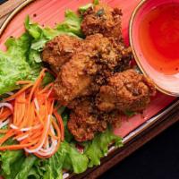 Butter Garlic Chicken Wings · Marinated with butter and deep-fried chicken wings, tossed with garlic and onion. Served wit...