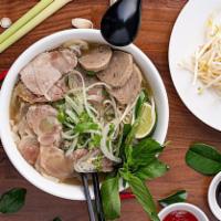 Saigon Special Pho · Rice noodle soup with sliced of rare beef, well done brisket, meatball, tendon and tripe. Se...