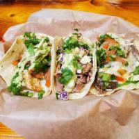 Brisket Tacos · 3 Corn Tortilla's filled with Slow Smoked Brisket, 3 Cheese Sauce, Pico and Cilantro