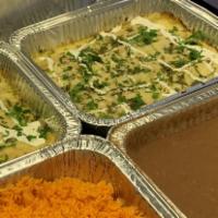 Enchiladas Suizas · 12 shredded chicken enchiladas covered with a creamy tomatillo sauce topped with melted chee...