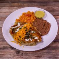 Enchiladas Suizas · 3 shredded chicken enchiladas covered with a creamy tomatillo sauce and topped with melted c...