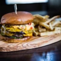 The Swill Inn Burger · Two 4oz patties, house pimento cheese and pickles, brioche bun.  Served with fries.