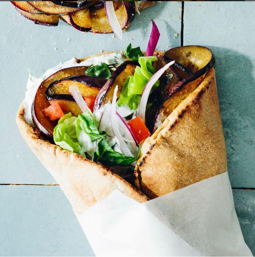 Mediterranean Veggie Wrap · Falafel and fresh eggplant served with choice of lettuce, tomatoes, onions, pickles, hummus, tahini, tzatziki, feta, tabouli, cucumbers, and banana peppers in a wrap. 