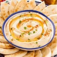 Hummus · A unique blend of chickpeas, tahini, lemon juice, salt and garlic. Served with pita bread on...