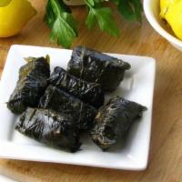 Grape Leaves · Stuffed with rice, parsley, tomatoes and cooked in olive oil. Served with pita bread and tza...