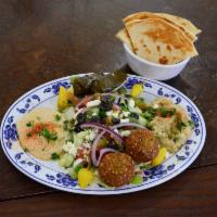 P3. Veggie Plate · 2 falafels, 2 dolmas with a side of hummus and a side of baba ghanoui eggplant.