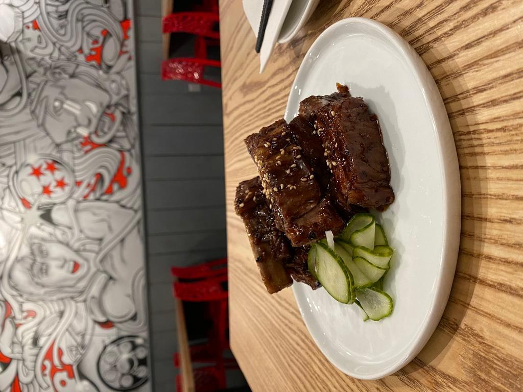 Black Bean Ribs · 1/2 rack baby back ribs with black bean sauce, honey, five spices, white pepper served with side of pickles