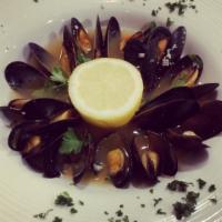 Steamed Mussels · Cooked in garlic white wine sauce.