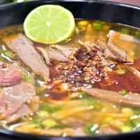 SPICY PHO AKA BUN BO HUE' · TRADITIONAL STYLE AUTHENTIC VIETNAMESE BUNH BO HUE SERVED WITH FAT NOODLES, MIXED VEGGIES, S...
