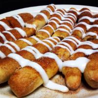Cinnamon Breadstix · Bread stix buttered & covered with cinnamon sugar. Topped with vanilla icing