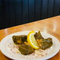 Dolmades · 2 grape leaves stuffed with rice, tomatoes, onions, parsley, red bell peppers, canola oil, e...
