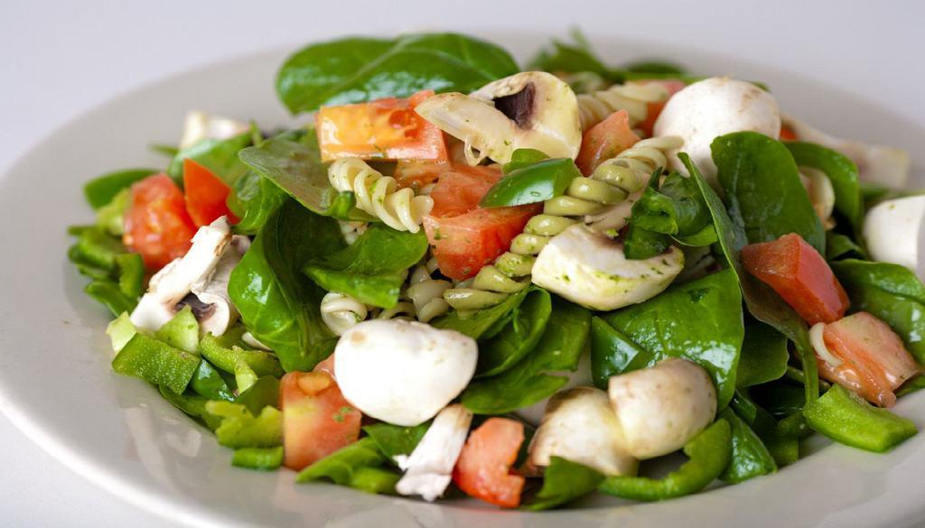 Spinach Pasta Salad · fresh spinach, tri-color rotini pasta, tomatoes, roasted mushrooms, bell peppers, pesto, za'atar and lemon vinaigrette