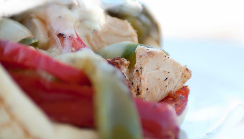 Philly Chicken Pita · grilled-marinated all-natural chicken breast, roasted bell peppers and onions, Swiss, Greek pita, wood-fired