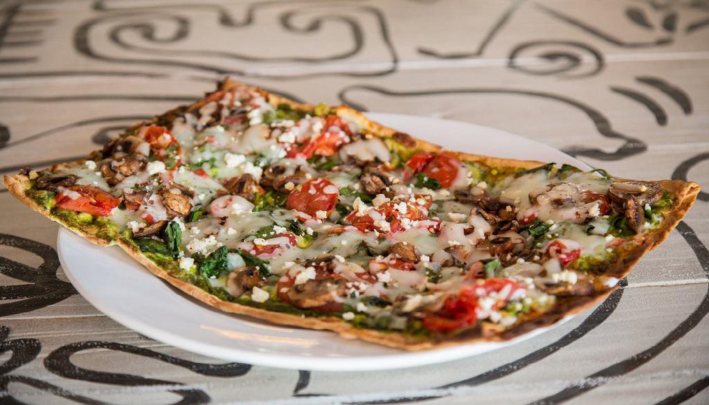 Spinach and Pesto Lavash Pizza · spinach, roasted mushrooms, wood-fired tomatoes, pesto, herbs, mozzarella, feta and thin lavash crust