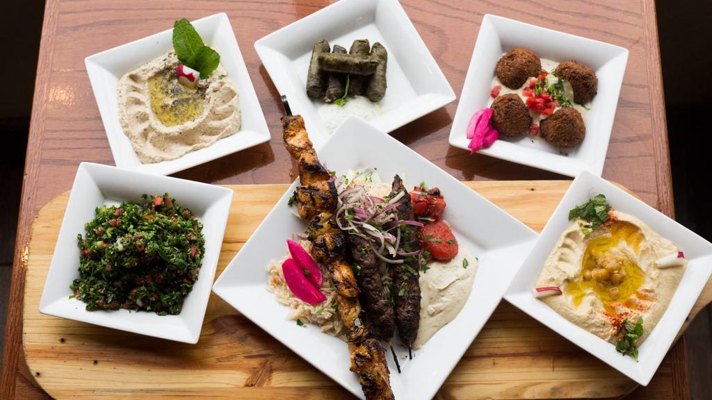 Taste of the Middle East · Serves 2. Two kafta kabobs & two chicken kabobs served on a bed of Basmati rice with humos, baba ghanouje, tabouleh, falafel and stuffed grape leaves.