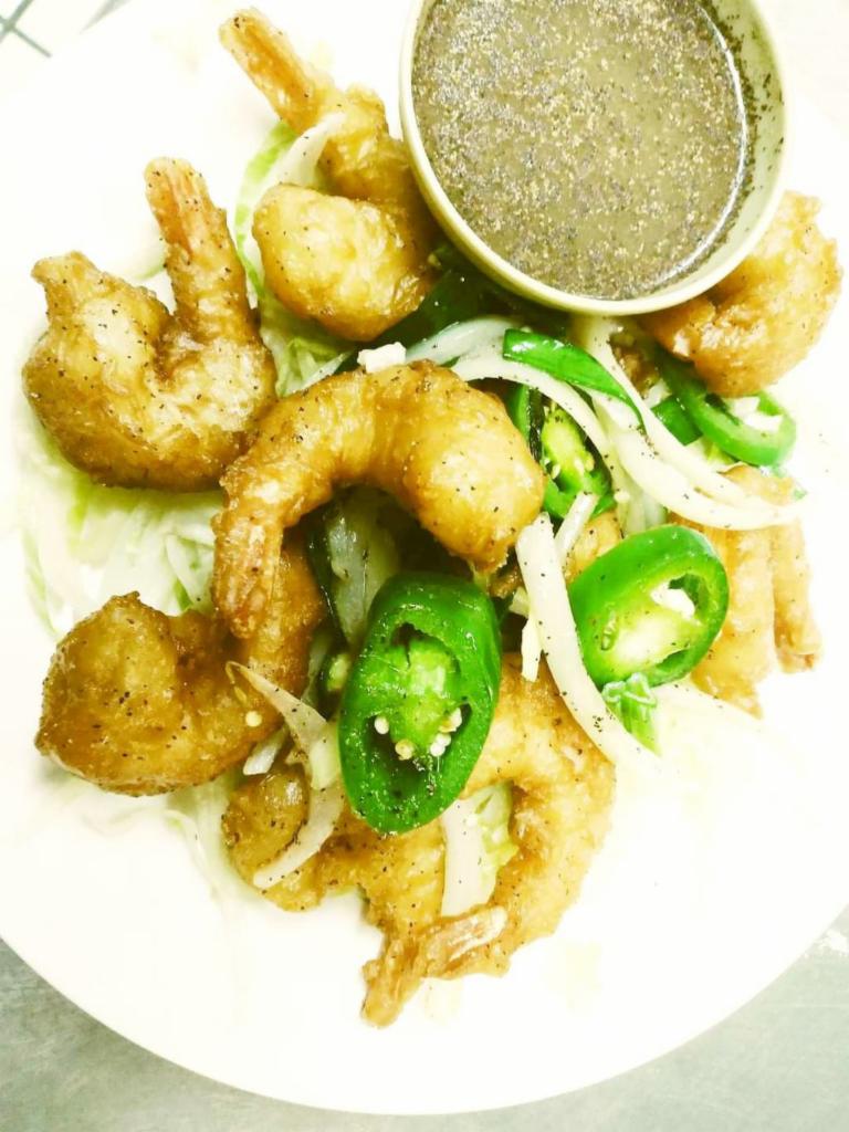 10 Dynamite Shrimp · Shrimp dipped in tempura batter fried crispy wok, tossed with garlic jalapenos, spring onion and house sauce on the side.
