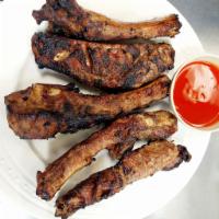 Grilled Pork Ribs · 5 marinated pork spare ribs char grilled.